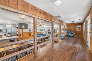 A spacious living area with a pool table, wooden flooring, and a fireplace. - Walk to the river! Pool table, huge living space (Strawberry)