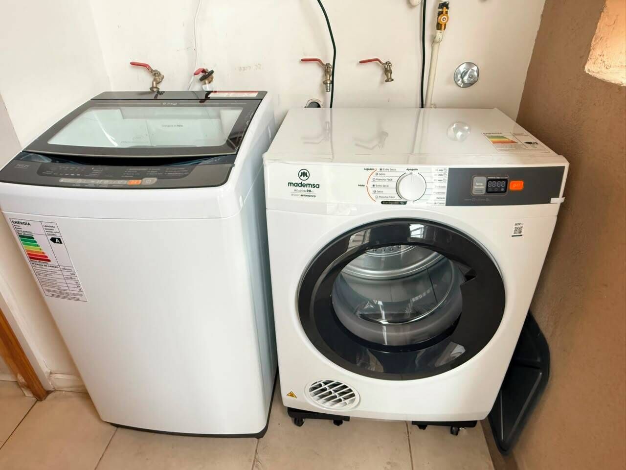 A compact laundry room with a front-loading washing machine and a dryer.