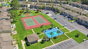 A residential area with a tennis court, a swimming pool, and a parking lot. - Gulf Highlands with a Golf Cart! (Panama City Beach)