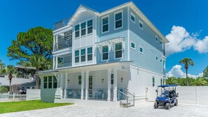 A two-story beachfront house with a covered porch and a visible number '26' on the facade. - Beacon: 30A beaches, sleeps 26, private pool! (Santa Rosa Beach)