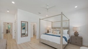 A bedroom with a four-poster bed, bedside lamps, and a large mirror. - Beacon: 30A beaches, sleeps 26, private pool! (Santa Rosa Beach)