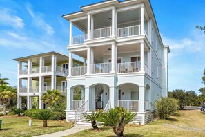 A multi-story building with balconies and a staircase leading to the upper floors. - Stones Throw - Luxury 5BR Beach Retreat at Kiva Dunes With Private Beach Club (Gulf Shores)