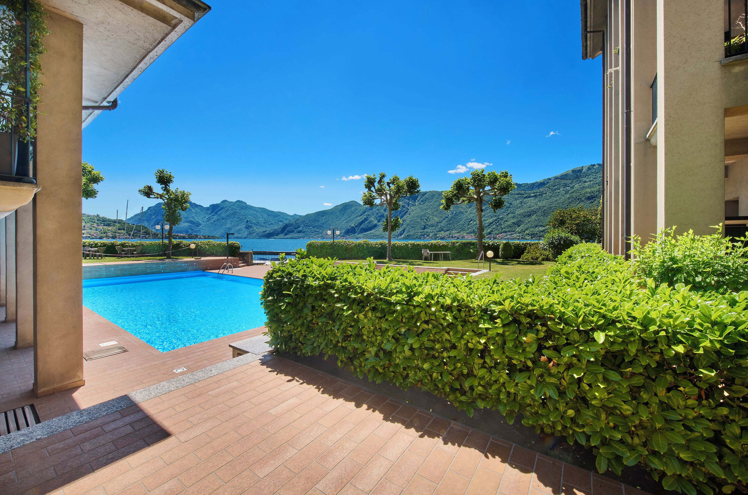 A swimming pool with a view of mountains and a clear sky.