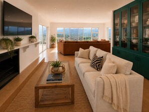A modern living room with a sofa, a coffee table, and a fireplace. - Sky Nova Villa False Bay Mountain & Ocean Views (Cape Town)