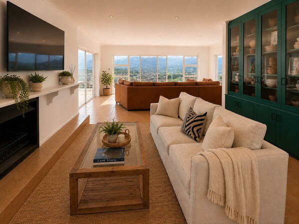 A modern living room with a sofa, a coffee table, and a fireplace.