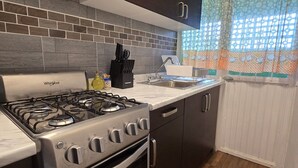 A kitchen with a gas stove, oven, and modern cabinetry.