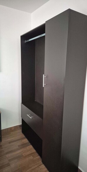 Un armario con puerta corredera y estante incorporado.