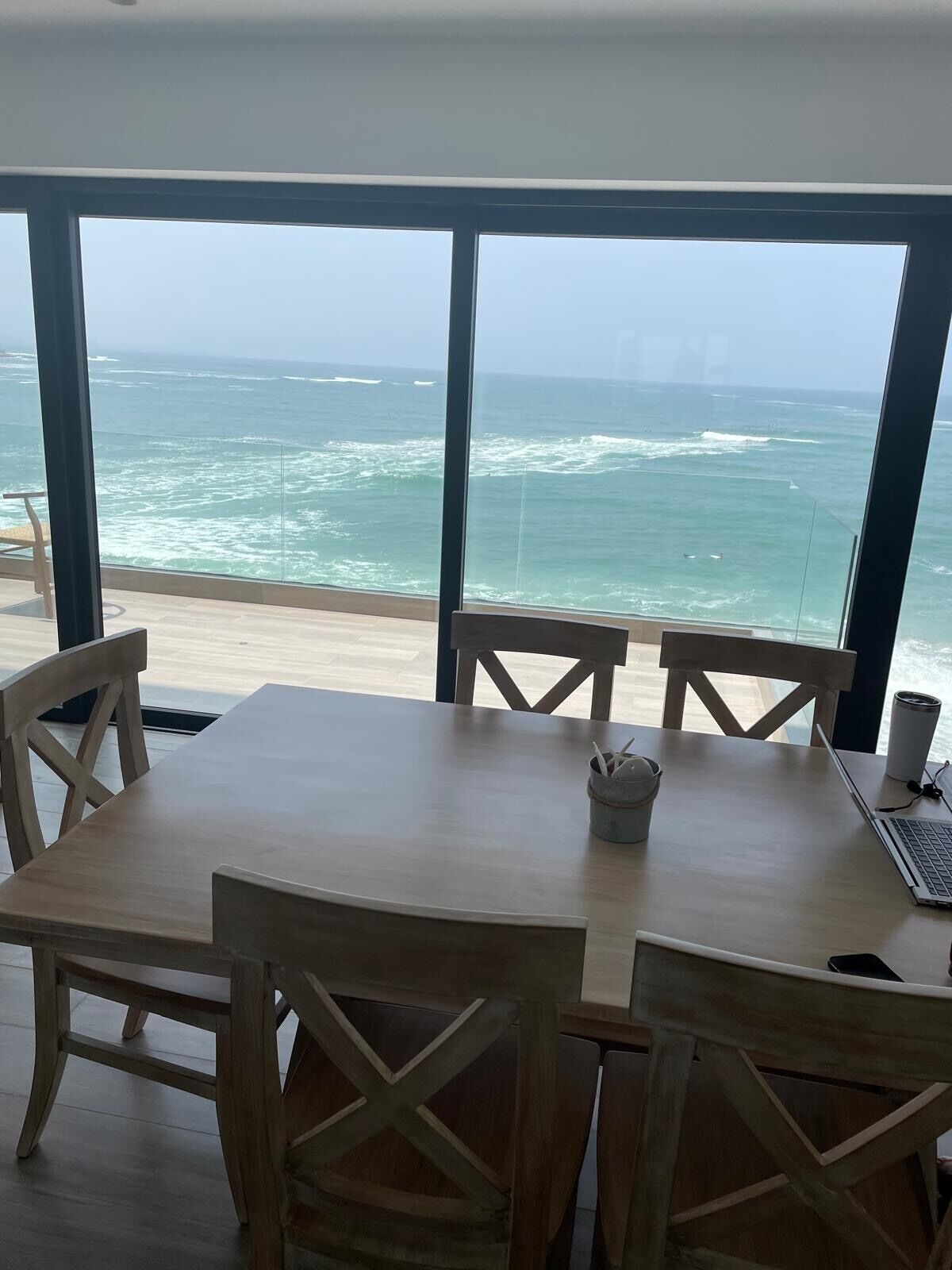 A dining area with a view of the ocean.