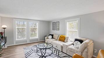 A living room with a sofa, coffee table, and a lamp.