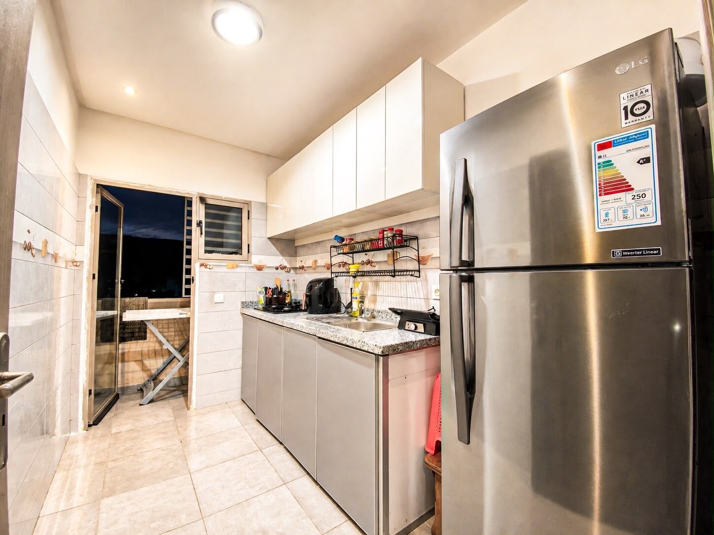 A modern kitchen with stainless steel appliances, including a refrigerator and a stove.