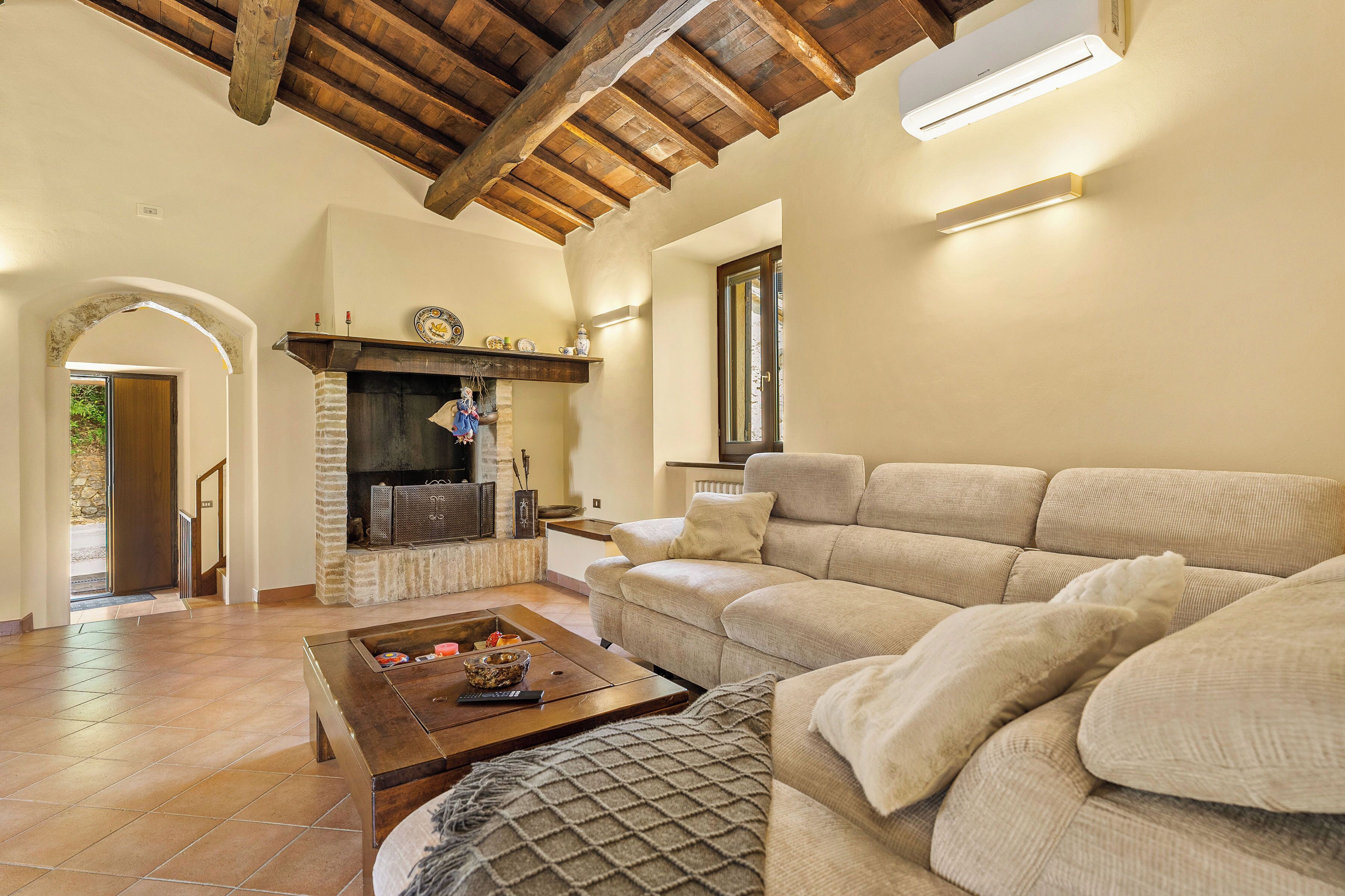 A living room with a fireplace, a sofa, and a coffee table.
