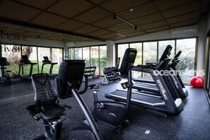 A gym with treadmills, exercise bikes, and dumbbells. - The Drifter • 2Bdr • Ocean View & Steps to Surf (El Zonte)