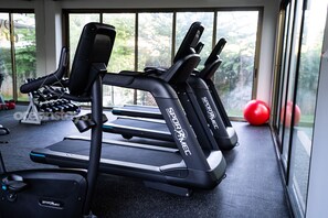 A gym with treadmills, weights, and a red exercise ball. - The Drifter • 2Bdr • Ocean View & Steps to Surf (El Zonte)