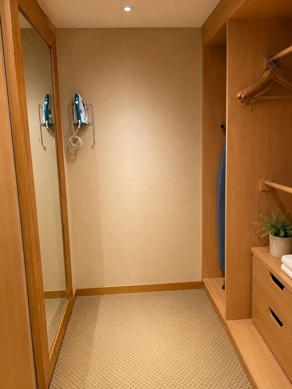 A walk-in closet with wooden doors, a hanging rack, and a small plant on a wooden dresser.