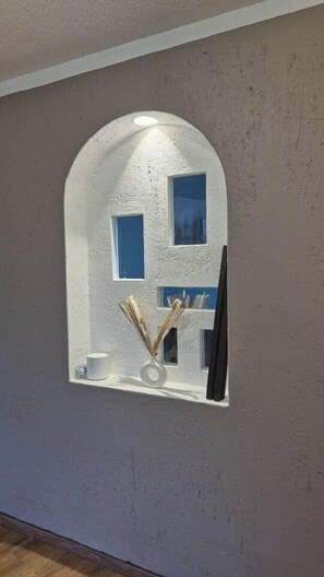 A wall-mounted mirror with a white frame and a small shelf below it. - Fabian (Rio de Janeiro) (Mexico City)