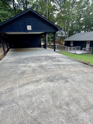 A covered parking area with a sign indicating 'Cox's Lake Escape.' - Cozy Lake Escape on Weiss Lake (Cedar Bluff)