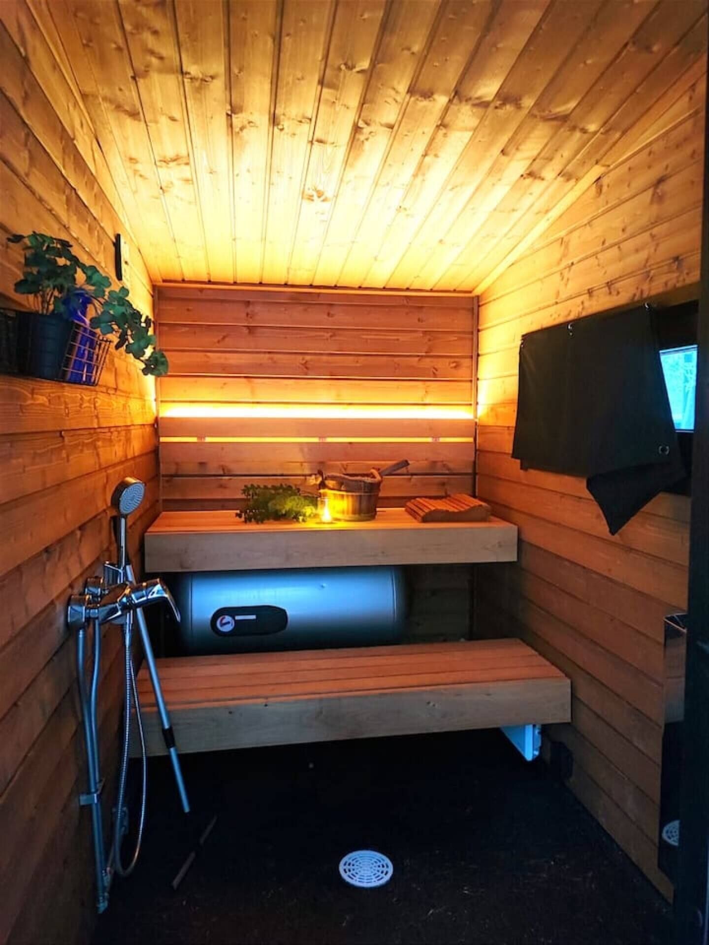 A sauna with wooden walls and a bench.