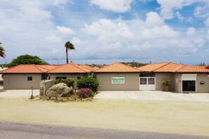 A building with a sign indicating it's a rental property. - Haven w/ Pool · King Bed · Near Palm Beach #9 (Noord)