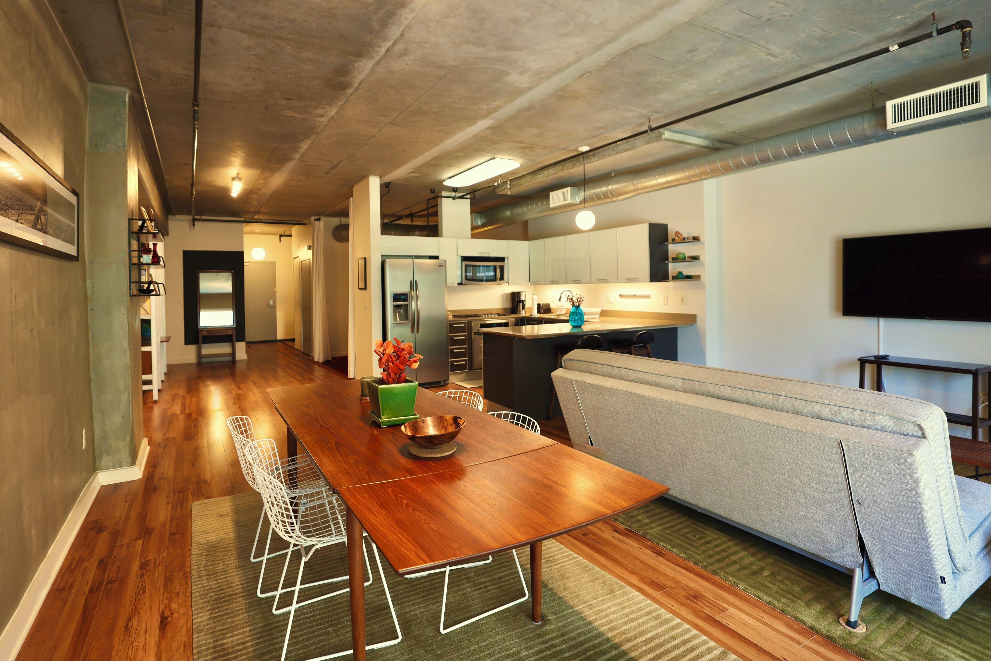 A modern kitchen with a microwave, stove, and refrigerator.