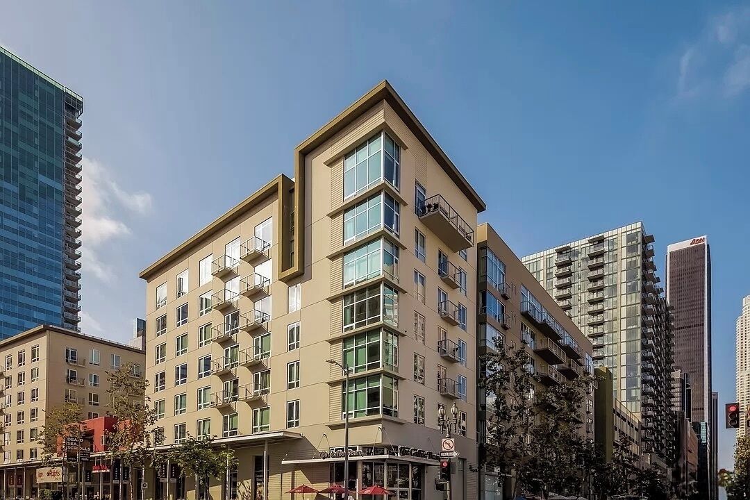 A multi-story hotel with a flat facade, large windows, and balconies.