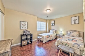 A child's bedroom with two beds, a desk, and a window with blinds. - Serenity Stay in Henderson with Pool! (Henderson)