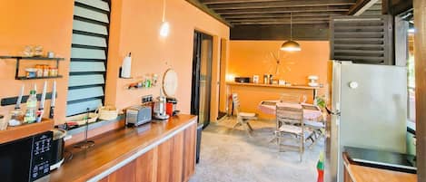 A kitchen with wooden cabinets, a built-in microwave, and a refrigerator.