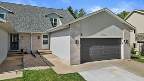 A residential house with a garage, a front door, and a small porch area.
