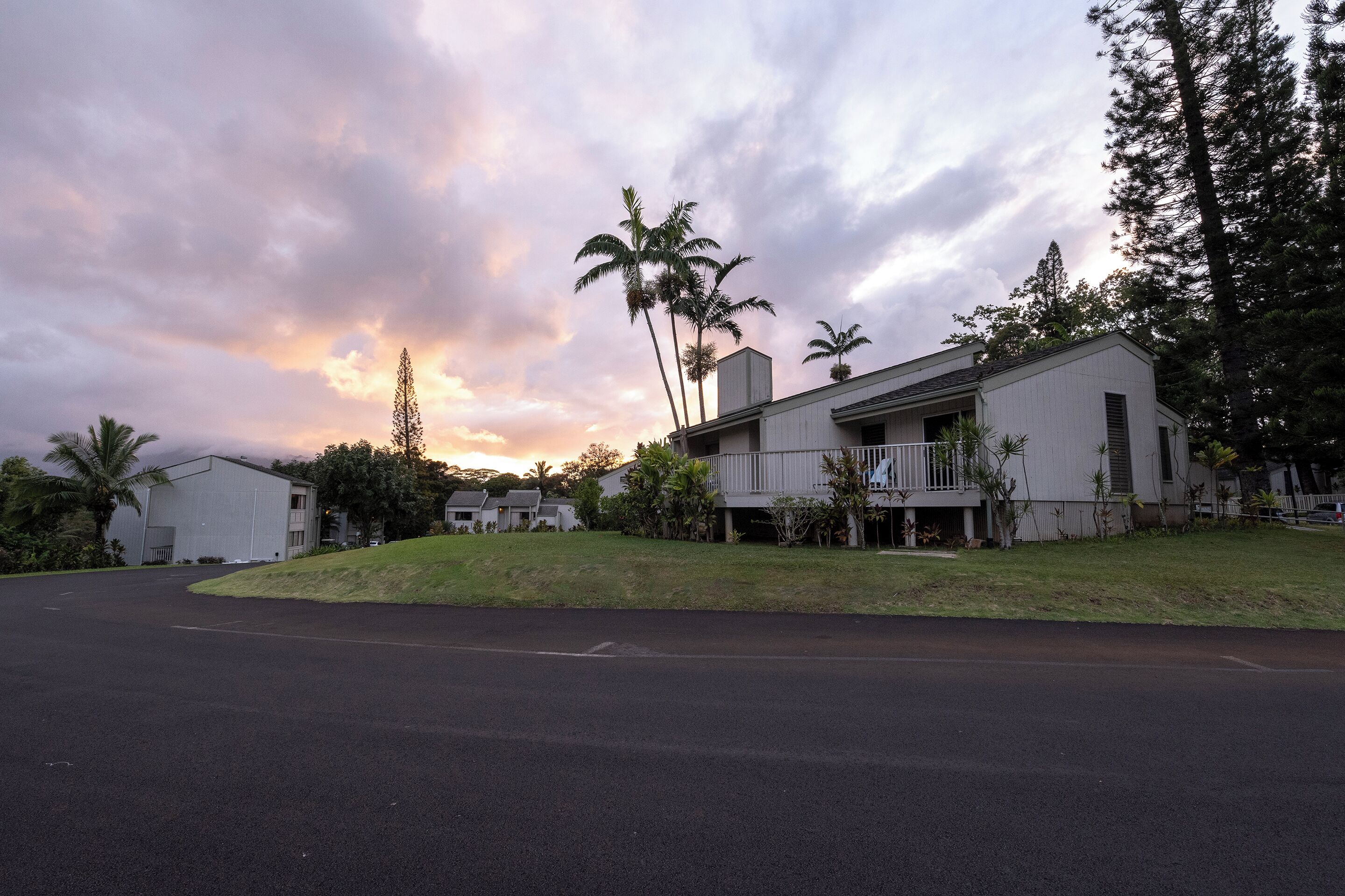 A residential area with a two-story house, a garage, and a driveway.