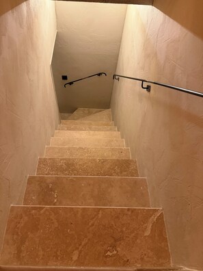 Eine Treppe mit Handlauf und einer Leuchte am oberen Ende.