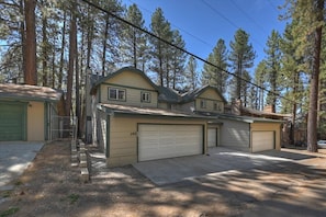 A two-story house with a garage, a covered driveway, and a fenced yard. - Summit Timber | 3-Min Walk to Snow Summit (Big Bear Lake)