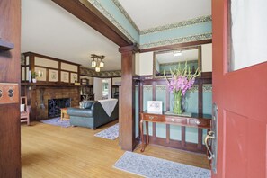 A traditional interior with a fireplace, a sofa, and a mirror. - Historic 3BR Monrovia Oasis with Pool, BBQ & Spa (Monrovia)