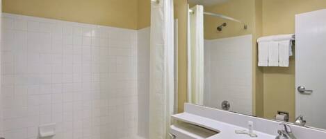 A bathroom with a bathtub, a toilet, a sink, and a shower.