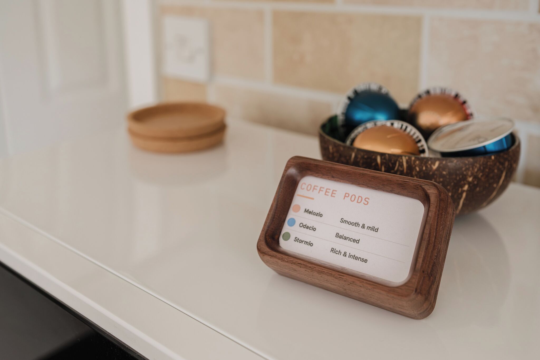 A coffee pod holder with labels for different types of coffee pods.