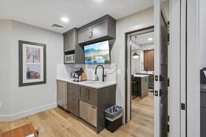 A modern kitchen with grey cabinets, a stainless steel dishwasher, and a built-in microwave. - Luxury Westgate 2BR | Canyons Village | Pools, Spa & Ski Valet (Park City)