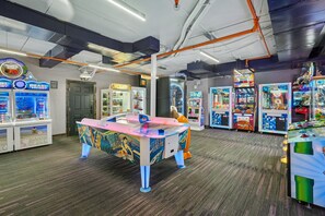 Eine Indoor-Spielehalle mit verschiedenen Spielautomaten, darunter ein großes Tischtennistisch und mehrere Spielautomaten mit Gewinnmöglichkeit.