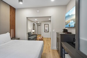 A hotel room with a bed, a desk, a chair, a TV, and a view of a mountain landscape. - Westgate Studio | Ski-In/Ski-Out | Pools, Spa & Ski Valet (Park City)