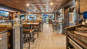 A restaurant interior with wooden flooring, bar area, and a ceiling with intricate designs. - Westgate Studio | Ski-In/Ski-Out | Pools, Spa & Ski Valet (Park City)