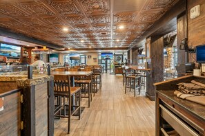 A restaurant interior with wooden flooring, bar area, and a ceiling with intricate designs. - Westgate Studio | Ski-In/Ski-Out | Pools, Spa & Ski Valet (Park City)