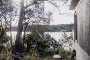 A house with a view of a lake and trees. - Waterfront at Eggs and Bacon Bay "theshack@84" (Huon Valley)