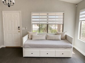 A bedroom with a bed, a window with blinds, a door, and a light fixture. - Gilbert Oasis • Near Downtown Gilbert • King Suite • Private Yard & Grill (Gilbert)