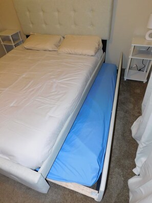 A bed with a white mattress and a blue mattress at the foot. - Affordable 3 bedroom Beach House in Murrells Inlet (Murrells Inlet)