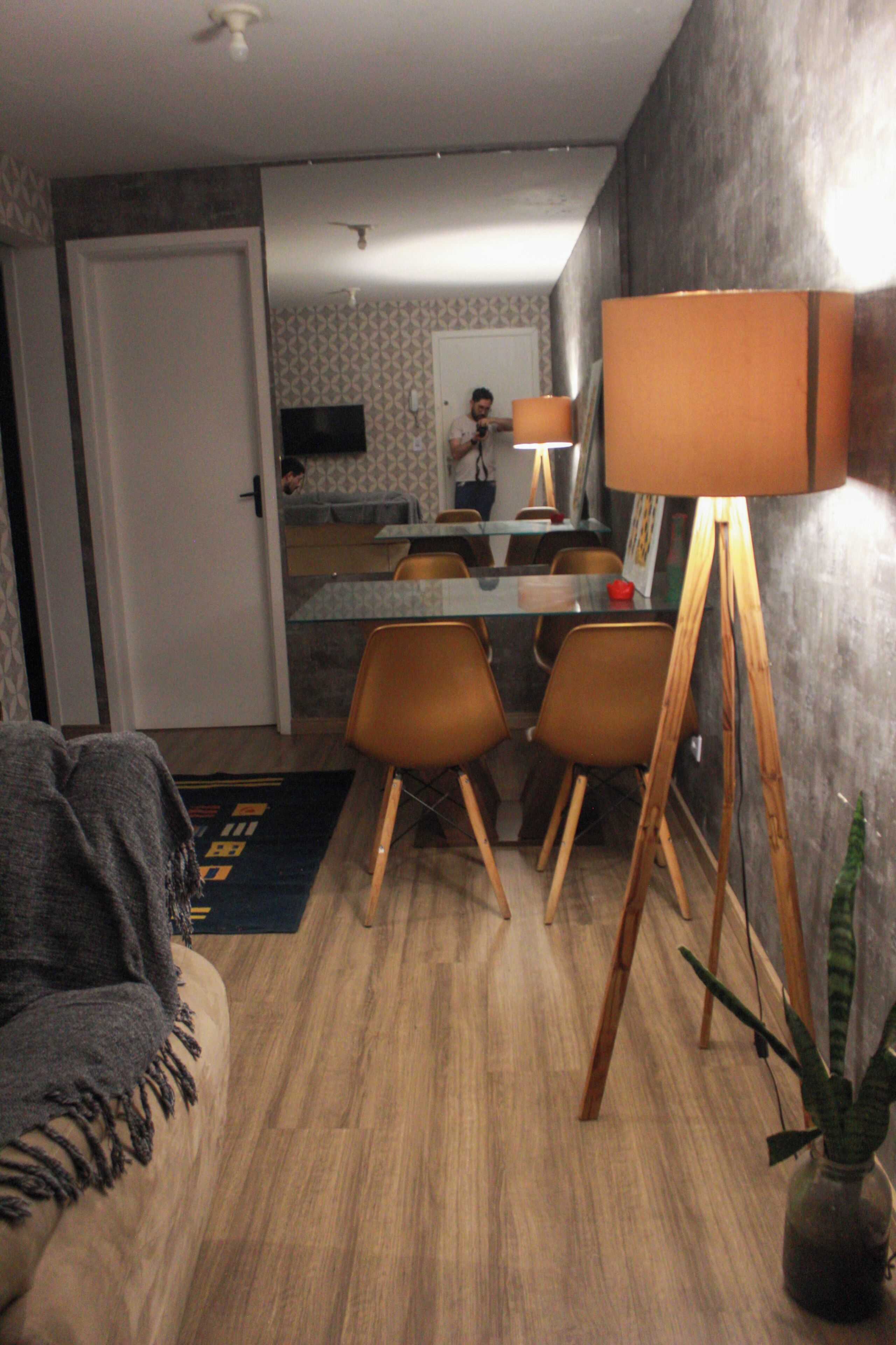 A dining area with a table, chairs, and a lamp.