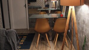 A dining area with a table, chairs, and a lamp.