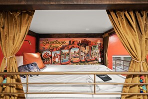 A bunk bed with a wall mural, curtains, and a pillow. - The Yucca House: Pool, Spa, Gym, Theater, Game Room | Epic Red Rock Views (Sedona)