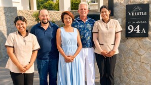 A group of people standing in front of a sign for Viluma Villa Amara, number 94A. - Villa Brisa - Viluma Villas (Hua Hin)