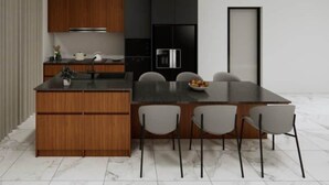 A modern kitchen with a central island, wooden cabinets, and a black refrigerator. - Villa Brisa - Viluma Villas (Hua Hin)