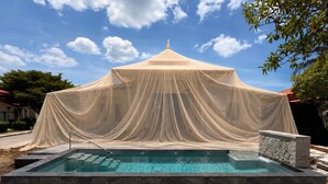 A swimming pool with a white canopy overhead. - Villa Brisa - Viluma Villas (Hua Hin)