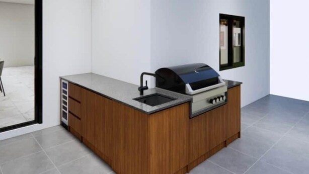 A modern kitchen with a built-in grill, a sink, and a wooden cabinet. - Villa Brisa - Viluma Villas (Hua Hin)