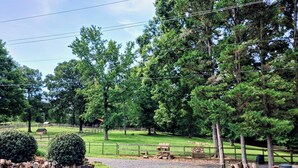 A rural landscape with a gravel path, wooden fences, and a small cabin. - Sunrise over the lake and mountains...  (Albemarle)
