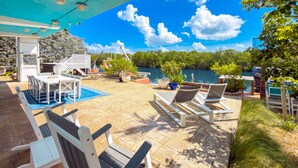 An outdoor patio with a pool, lounge chairs, and a dining area. - Bayside - Islamorada Waterfront, 360 Viewing Deck, Htd Swim Spa (Islamorada)